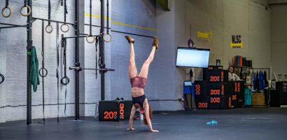 female athlete performs handstand walk
